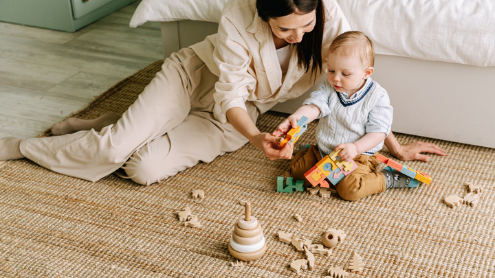 Mother and Daughter With Cluttered Toys That Need A Basket